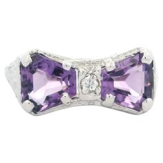 --Stone(s):-- (2) Natural Genuine Amethyst - Custom Cut - Prong Set - Light Purple Color - 6.67 x 5.92mm (approx.) (1) Natural Genuine Diamonds - Round Brilliant Cut - Prong Set - White Color - 0.03ctw (approx.) Material: 18k White Gold Top - 14k White Gold Shank Weight: 2.70 Grams Ring Size: 7 (Fitted on a finger. We can custom size this ring. Please contact us prior to purchase for sizing inquiries.) Ring Width: 8.32mm (0.32")(top of the ring - north to south), 1.61mm (bottom of the shank) Rin Formal Diamond Birthstone Ring With Gemstone Accents, Formal Sterling Silver Birthstone Ring With Accent Stones, Heirloom Amethyst Ring With Accent Stones For Formal Occasions, Heirloom Amethyst Ring With Accent Stones For Formal Events, Heirloom Birthstone Ring With Gemstone Accents For Formal Occasions, Heirloom Birthstone Ring With Gemstone Accents For Formal Events, Heirloom Formal Birthstone Ring With Gemstone Accents, Formal Platinum Jewelry With Accent Stones, Elegant Amethyst Birthstone Ring For Formal Occasions