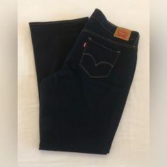 Elevate Your Denim Game With These Stylish Levi's 315 Jeans For Women. Crafted From A Blend Of Polyester, Cotton, And Elastane, These Dark Blue Bootcut Jeans Feature A Solid Pattern And A Zip Closure. The Mid-Rise ( 10.5 In) Jeans Have A Regular Fit And A Waist Size Of 40 Inches, With A 5-Pocket Design And Levi's Logo Accents. The Stretchy Fabric And Easy Care Features Make These Jeans Perfect For All Seasons, Whether It's Winter, Summer, Fall, Or Spring. Machine Washable And Designed To Provide Levi's Blue Flare Jeans, Levi's Denim Blue Jeans For Workwear, Levi's Denim Blue Workwear Jeans, Dark Blue Bootcut Jeans, Blue Bootcut Jeans, Dark Blue Denim, Modern Wardrobe, Jeans For Women, Solid Pattern