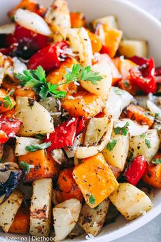 a white bowl filled with potatoes and vegetables