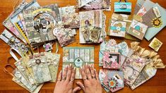 a table topped with lots of different types of cards and paper work on top of it