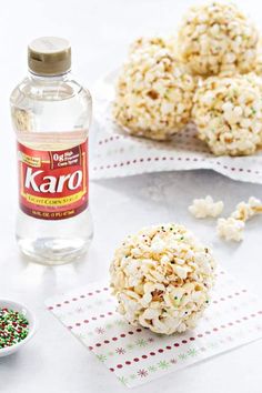 rice krispy kreme balls are sitting on napkins next to a bottle of water