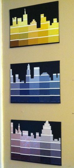 three different colored cityscapes mounted on a wall