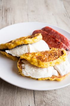 corn cakes with cheese are on a white plate and the words, cachapass corn cakes with cheese