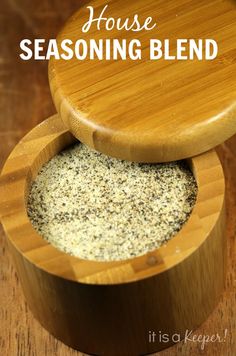 a wooden container filled with seasoning sitting on top of a table