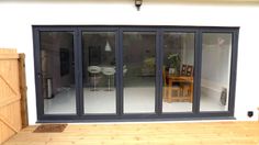 an open patio with sliding glass doors and wooden flooring