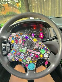 the steering wheel is decorated with colorful stickers