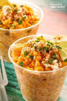 two plastic cups filled with macaroni and cheese, garnished with cilantro