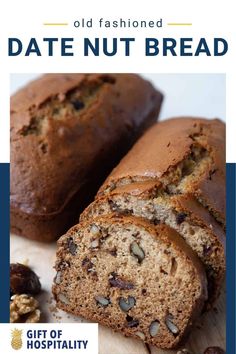 a loaf of date nut bread cut in half and sitting on top of a cutting board