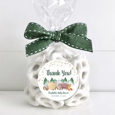 a bag filled with white marshmallows and a green bow