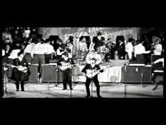 an old black and white photo of people on stage with instruments in front of them