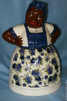 a ceramic figurine in the shape of a woman with blue and white flowers