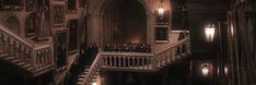 people are standing on the stairs in an old building