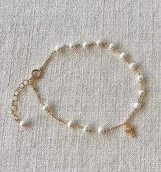 This is a dainty fresh pearl rosary chain bracelet. This minimalist chain bracelet is made of Natural fresh pearl wire wrapped in gold filled. It is fine and delicate, very feminine and elegant, beautiful. I use 4mm natural fresh pearl.   All components are gold filled. Fresh pearl and Gold are the best combination. This bracelet is 6.5", but there's a length adjustable chain for generous use.  You can mix and match this bracelet with other jewelry. Pearl Gold Chain, Minimalist Chain, Pearl Rosary, Rosary Bracelet, Rosary Chain, June Birthstone, June Birth Stone, Bracelet Gold, Pearl Bracelet