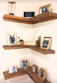 three shelves with pictures and frames on them