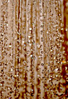 rain drops falling down from the ceiling in front of a window with brown and white background