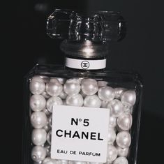 a bottle filled with lots of white pearls