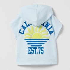 New "California" Embossed Hooded T-Shirt Sleeveless Tshirt With Hood. Front And Back Print With Raised Detail 9-12 Months Blue Hooded Tops For The Beach, Blue Hooded Tops For Beach, Blue Hooded Top For Beach, Blue Hooded Beach Tops, Hooded Beach Tops For Summer, Hooded Summer Beach Tops, Hooded Beach Tops For Spring, White Hooded Tops For Summer, Casual Blue Hooded T-shirt