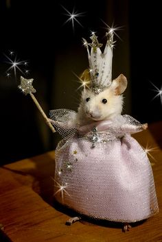 a little mouse in a pink dress with a tiara and sparkles on it's head