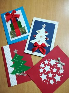 three christmas cards with bows on them and one is made out of red, white and blue paper