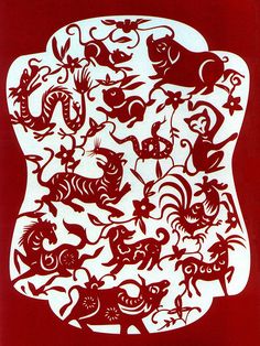 a red and white paper cut with various animals on it