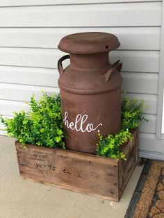 a large brown vase sitting on top of a wooden crate next to a planter