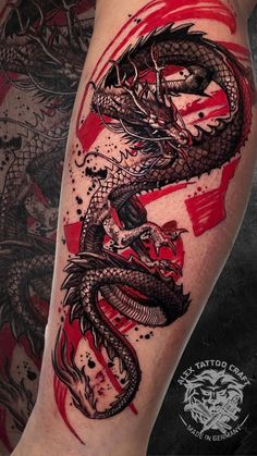 a black and red dragon tattoo on the leg