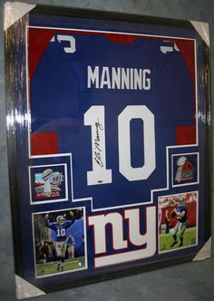 a framed new york giants jersey hangs on the wall in front of a sign that reads manning 10