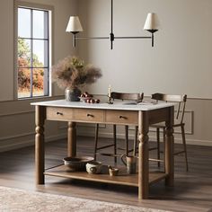 a kitchen island with two pots and pans on it in front of a window