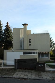 a modern house with two garages on the side