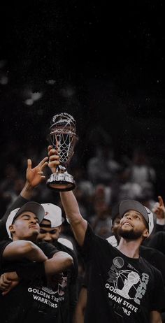 the men's basketball team is holding up their trophy in celebration after winning the title