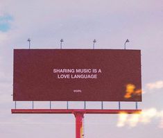 a large billboard on the side of a road that says sharing music is a love language