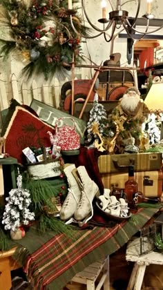 an assortment of christmas items on a table in a room filled with furniture and decorations