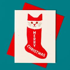 a red and white christmas card with a cat in a stocking