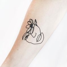 a woman's arm with a black and white line drawing of a flower on it