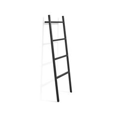 a ladder leaning up against a white wall