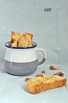 two pieces of bread in a bowl next to a piece of biscuit