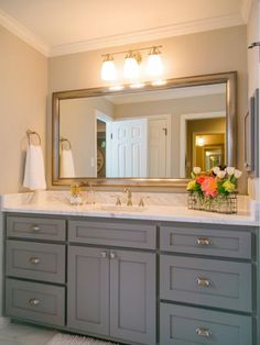 a bathroom with two sinks and a large mirror