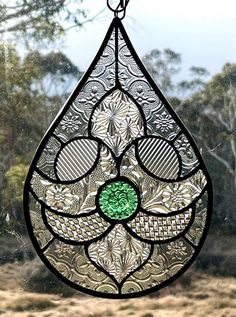 a stained glass window hanging from a chain