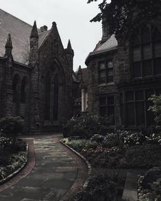 an old building with many windows and lots of flowers