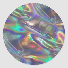 an iridescent background with lots of colors round sticker on the side of a wall