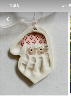 an ornament that looks like a santa clause hanging from a christmas tree branch