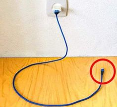 an electrical outlet connected to a wall with a red and blue wire running through it