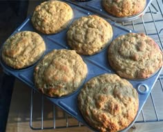 several muffins are sitting on a cooling rack in the oven, ready to be baked