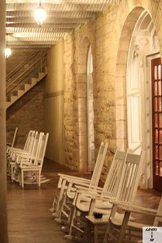 there are many chairs lined up on the floor in front of an open door and stairs