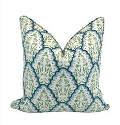 a green and white pillow with blue trim