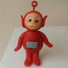 a red plastic toy with eyes and arms