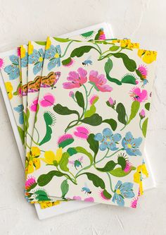 three napkins with colorful flowers on them