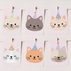 six cat birthday cards hanging from clothes pins with party hats and cats on them, all in pastel colors