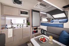 the interior of an rv with a bed and breakfast tray