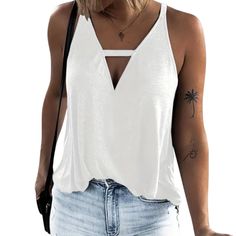 a woman wearing a white tank top with cutouts on the front and back sides